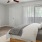 a bedroom with a bed and a fan