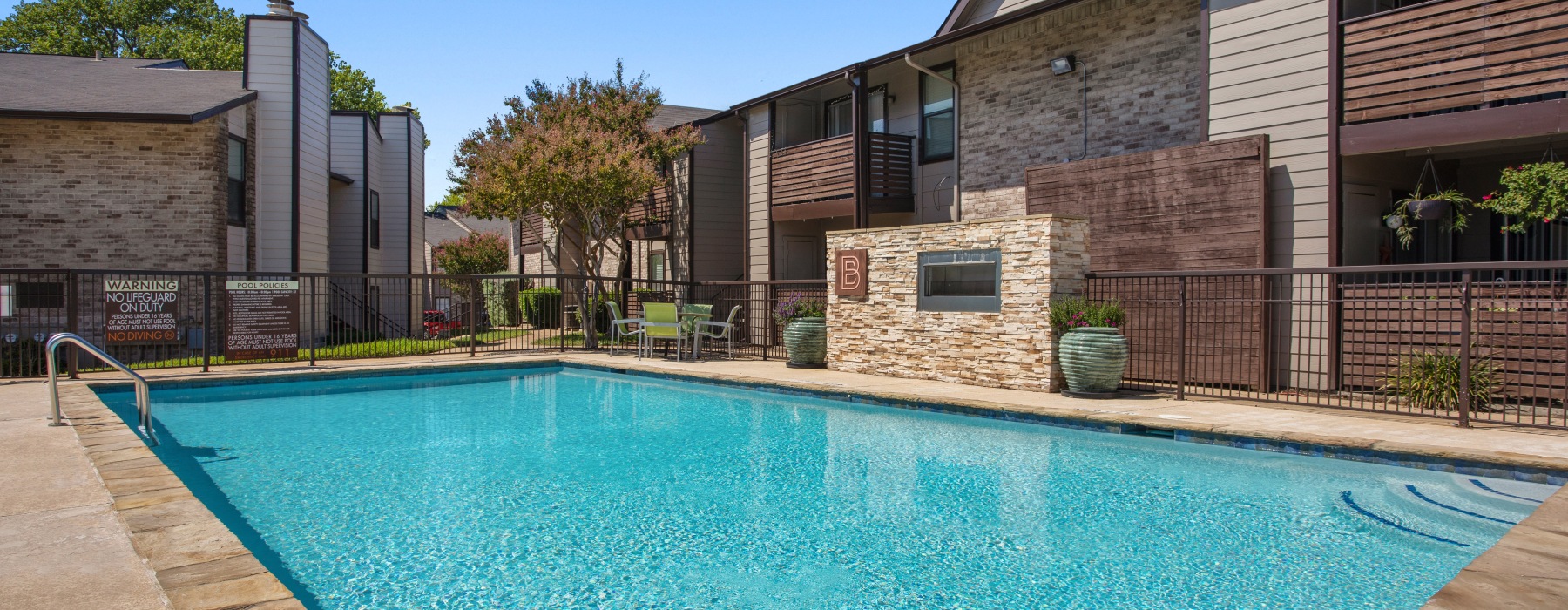 community swimming pool with apartment buildings in the background