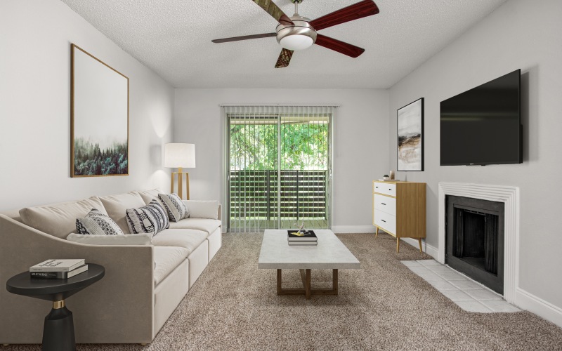 Living room with ceiling fan and fireplace