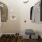 a closet with clothes hanging and shoes lined up in the floor