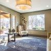 a room with a lot of natural light and seating areas