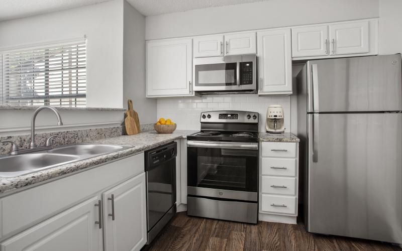 a kitchen with white cabinets