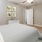a bedroom with a ceiling fan and a bed