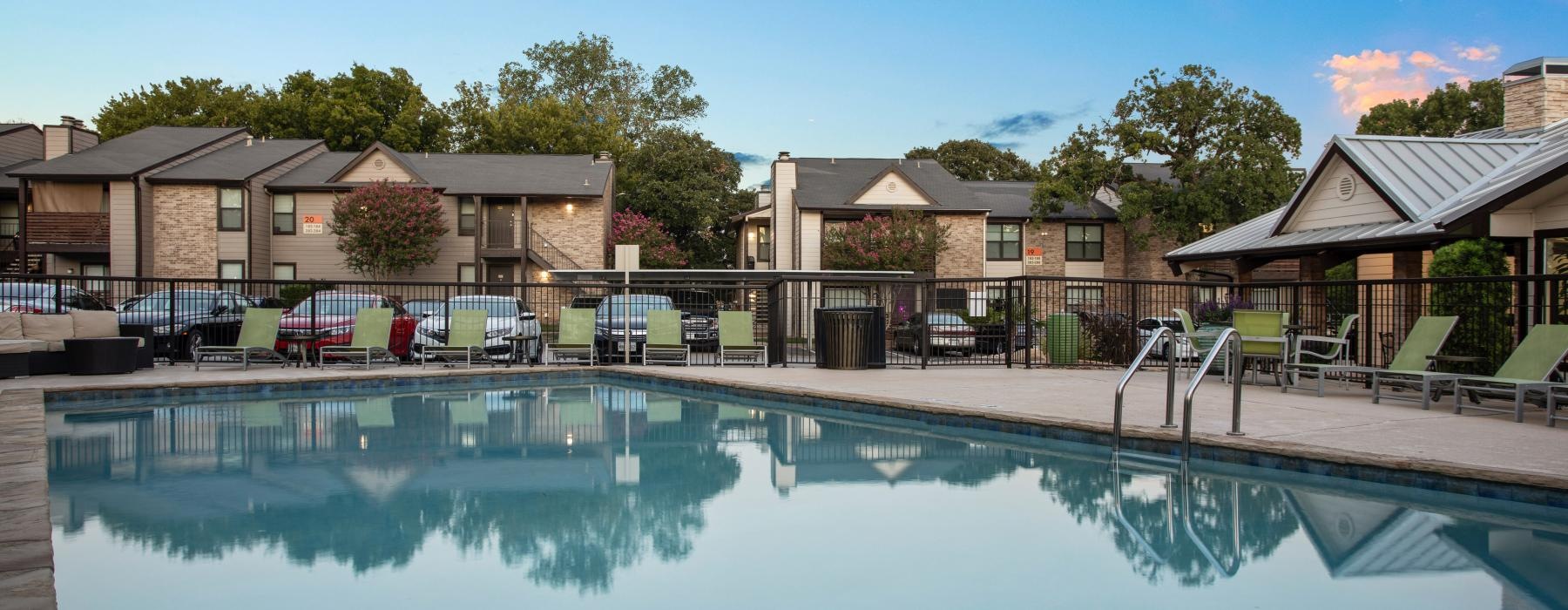 community swimming pool with apartment buildings in the background